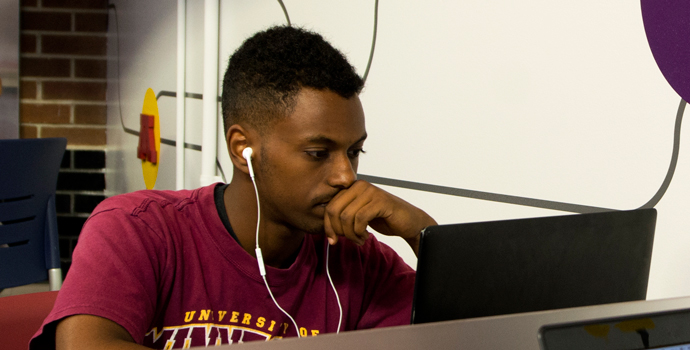 A student studies on his laptop