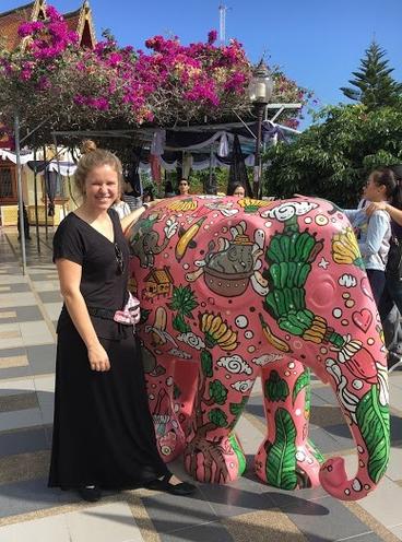 A student poses with an elephant statue