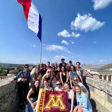 Students with the French Flag at the Arc de Triomphe