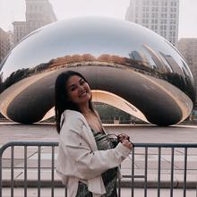 Hannah, smiling and standing in front of the Bean in Chicago